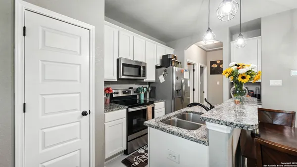 a kitchen that has a refrigerator and a stove in it
