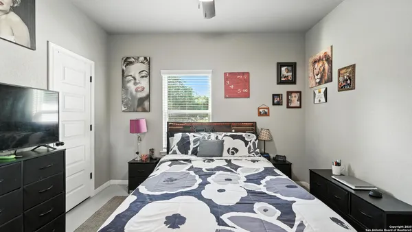 a bedroom with a bed and a tv on the dresser