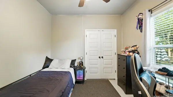 a bedroom with a bed and a flat tv screen