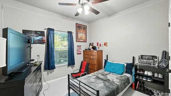 a bedroom with furniture and a flat screen tv