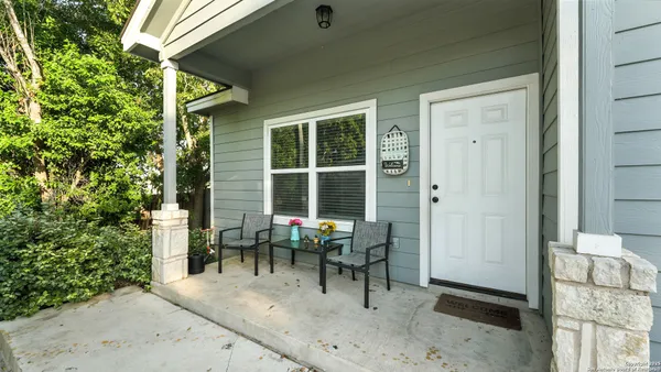 a view of a house with backyard sitting area and garden