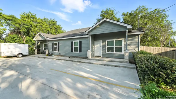 a view of a house with a yard and plants