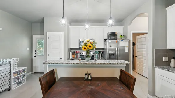a kitchen with stainless steel appliances kitchen island granite countertop a sink and dishwasher