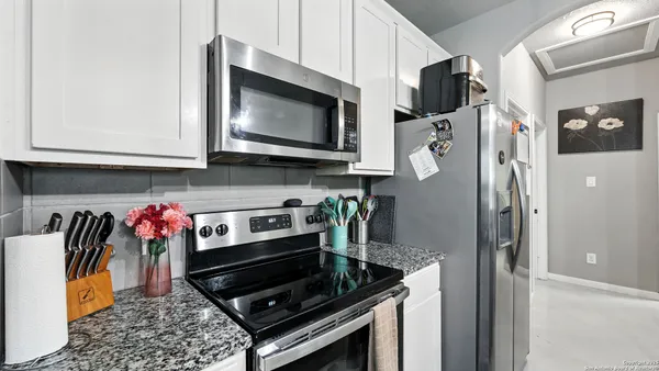a kitchen with stainless steel appliances granite countertop a stove a microwave and cabinets