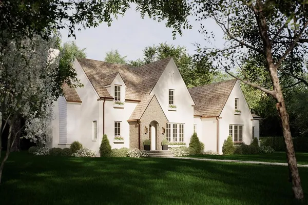 a view of white house with a big yard and large trees
