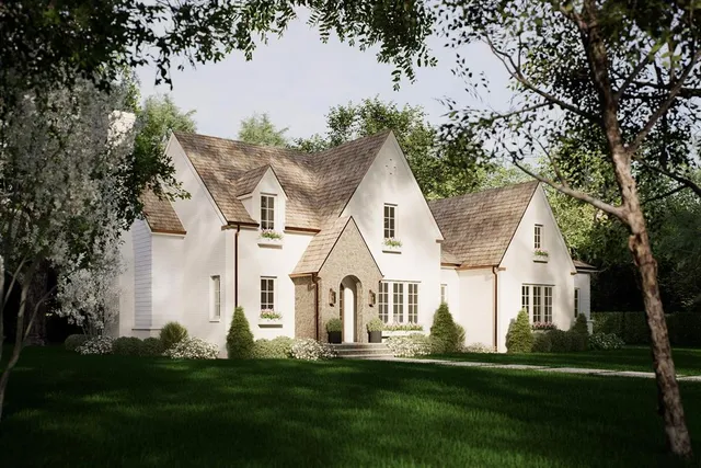 a view of white house with a big yard and large trees