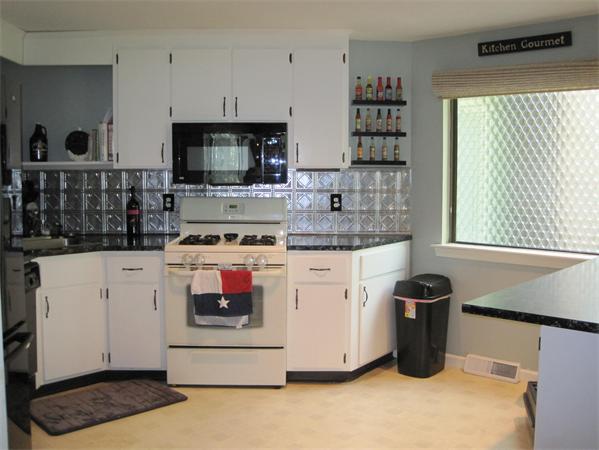 1 Mountain Gate Road, Unit 1 Ashland, MA 01721 - Photo 5 of 13 a kitchen with stainless steel appliances granite countertop a stove and a refrigerator