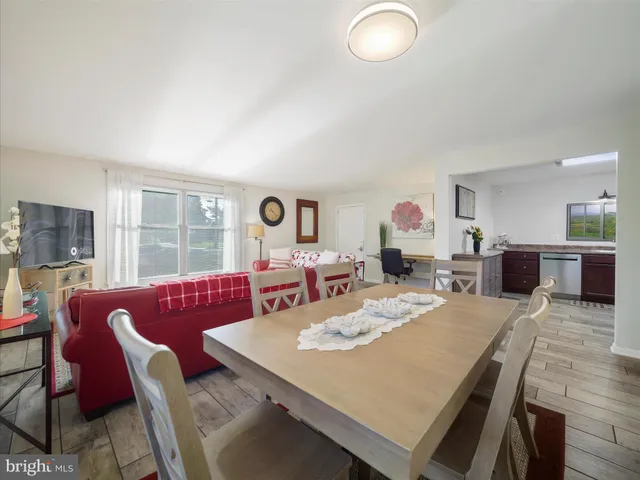 a view of a dining room with furniture and a large window