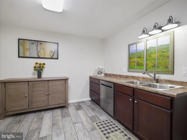 a kitchen with sink and cabinets