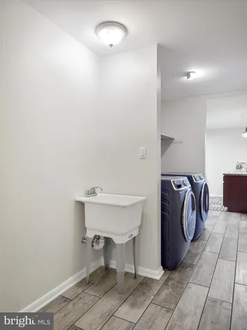 a bathroom with a sink toilet and a mirror