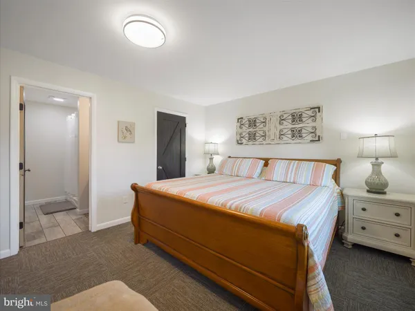 a bedroom with a bed and a lamp