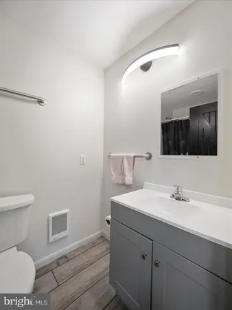 a bathroom with a sink toilet and mirror