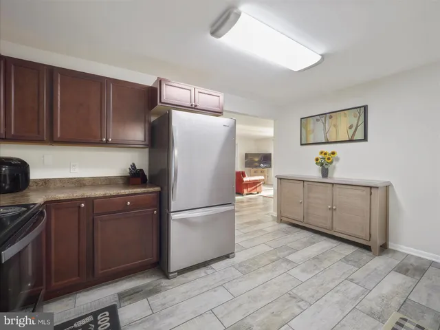 a kitchen with cabinets a refrigerator and a sink