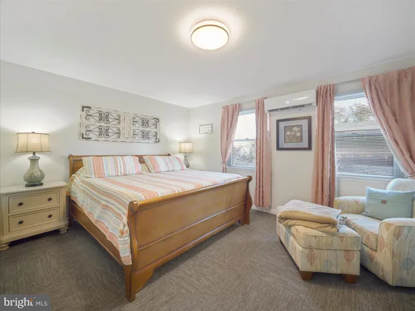 a spacious bedroom with a bed and a window
