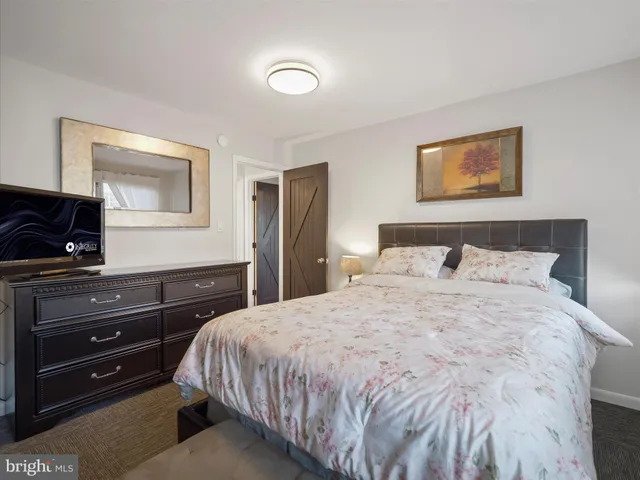 a bedroom with a bed and a dresser