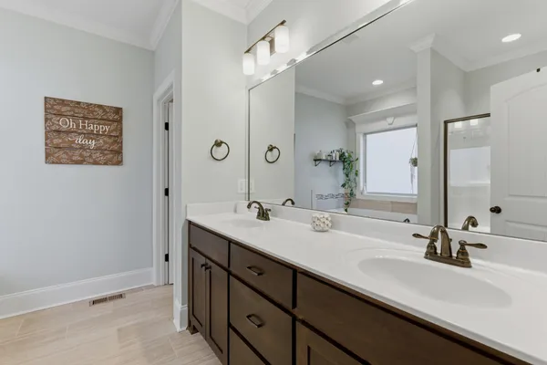 a bathroom with a sink double vanity and a mirror