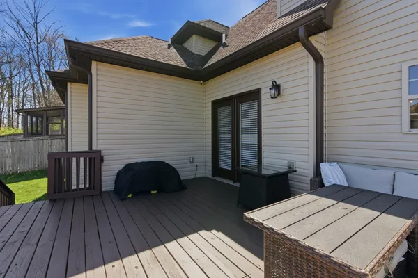 a view of a roof deck with wooden floor and seating space