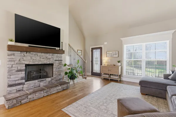 a living room with furniture flat screen tv and a fireplace