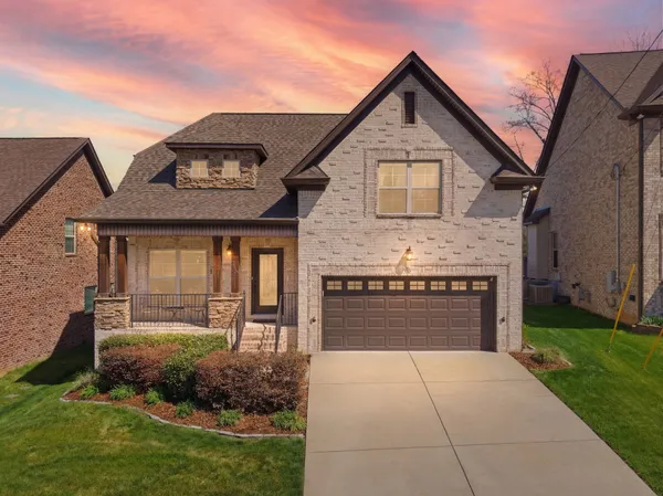 a front view of a house with a yard and garage