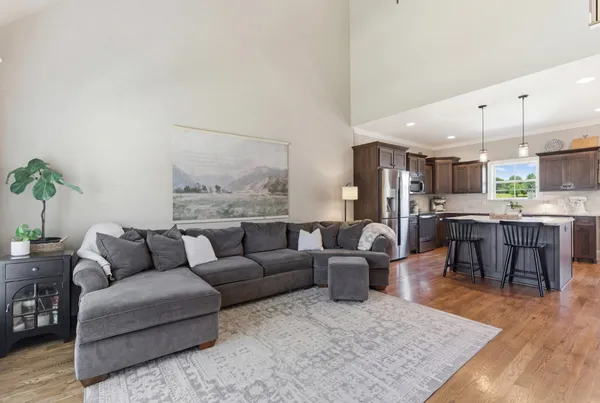 a living room with furniture kitchen view and a table