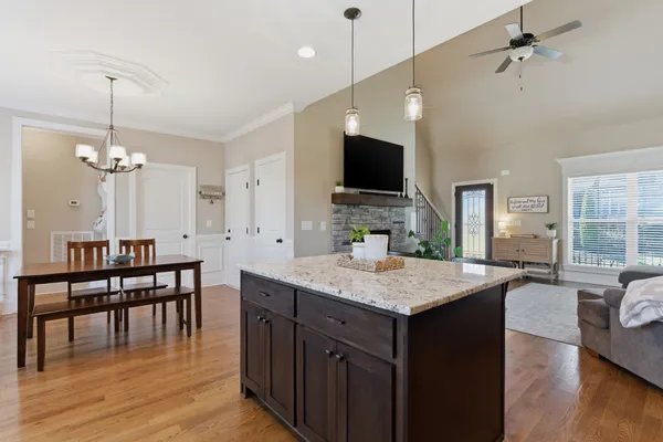 a kitchen with a table chairs refrigerator and microwave