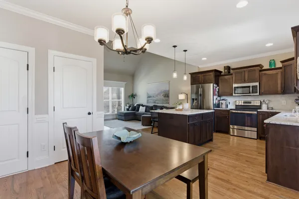a large kitchen with a table and chairs