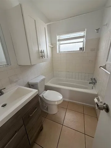 a bathroom with a sink a toilet and bathtub
