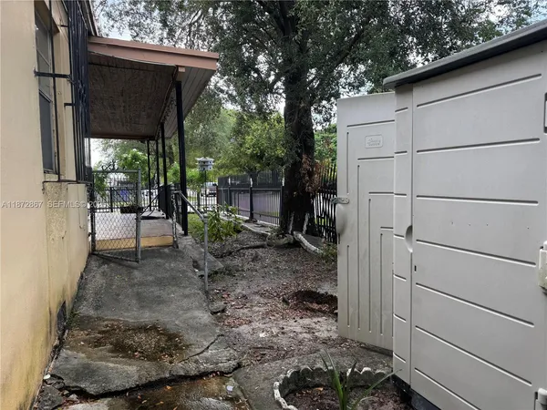 a view of a porch with furniture and a yard