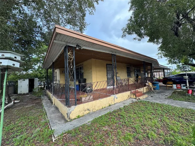 a view of a house with backyard porch and sitting area