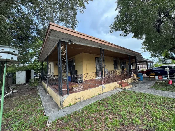 a view of a house with backyard porch and sitting area