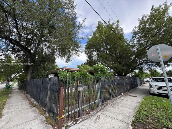 a view of house with backyard and outdoor seating