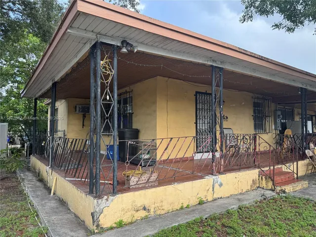 a view of house with yard and patio