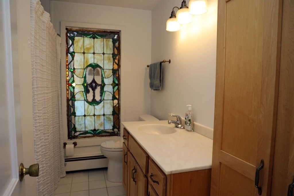 55 Rebecca Road Scituate, MA 02066 - Photo 19 of 27 a bathroom with a sink mirror and vanity