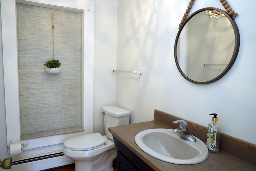 55 Rebecca Road Scituate, MA 02066 - Photo 20 of 27 a bathroom with a sink toilet and a mirror