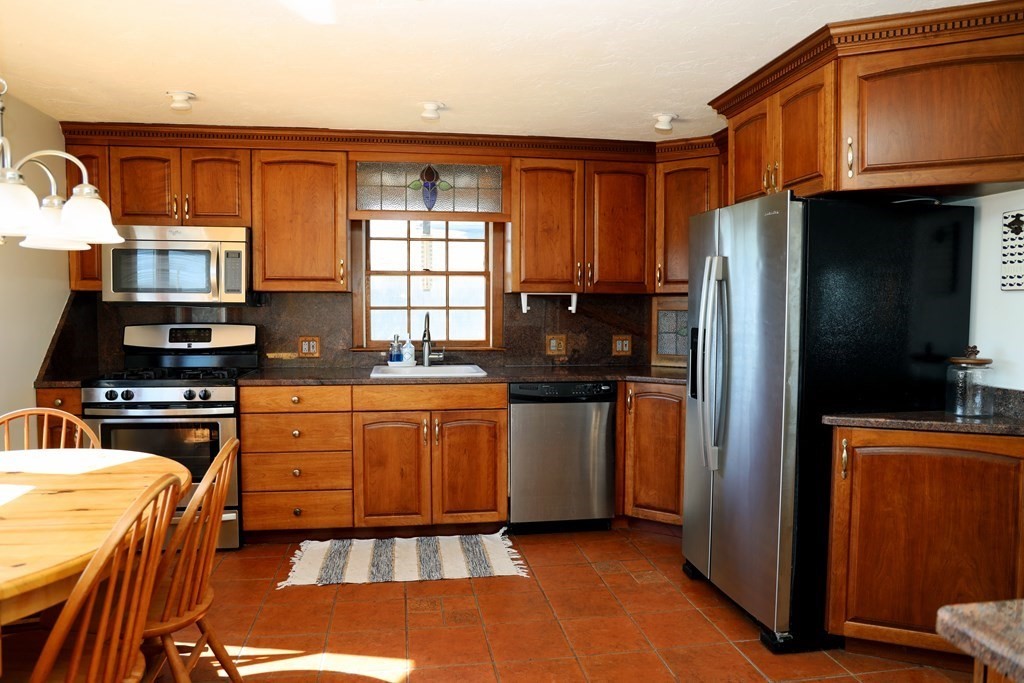 55 Rebecca Road Scituate, MA 02066 - Photo 8 of 27 a kitchen with stainless steel appliances granite countertop a refrigerator stove top oven a sink and dishwasher