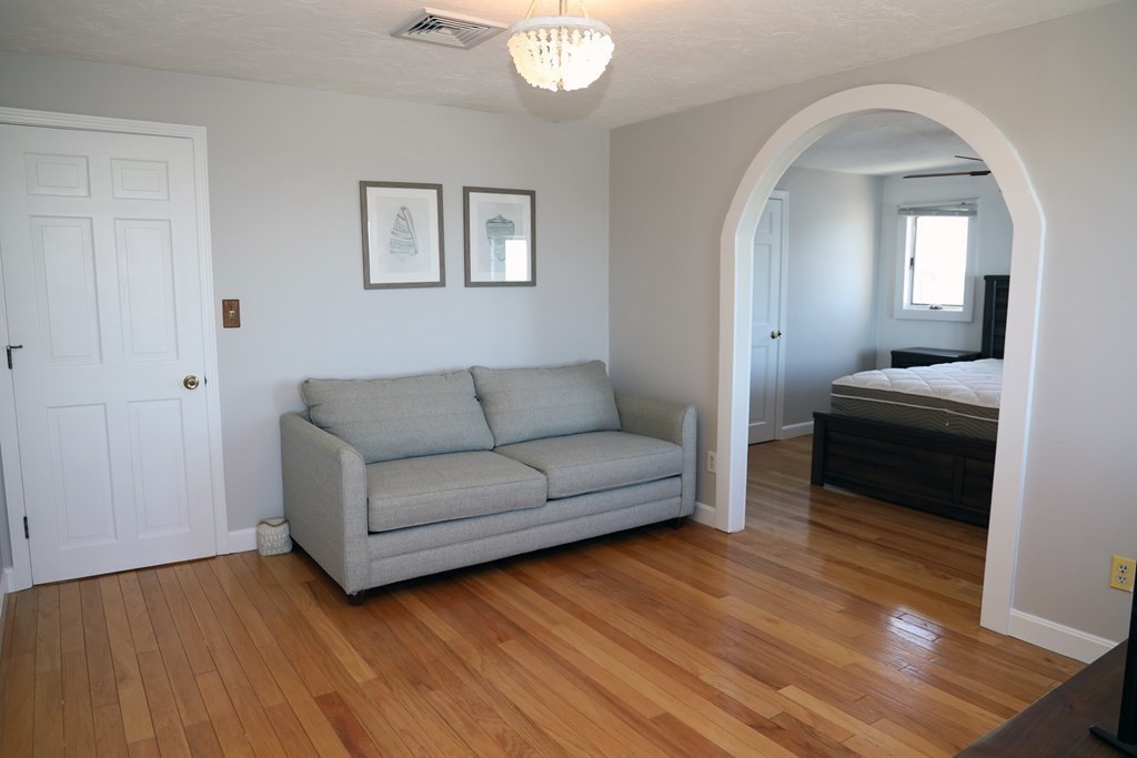 55 Rebecca Road Scituate, MA 02066 - Photo 10 of 27 a living room with furniture and a mirror