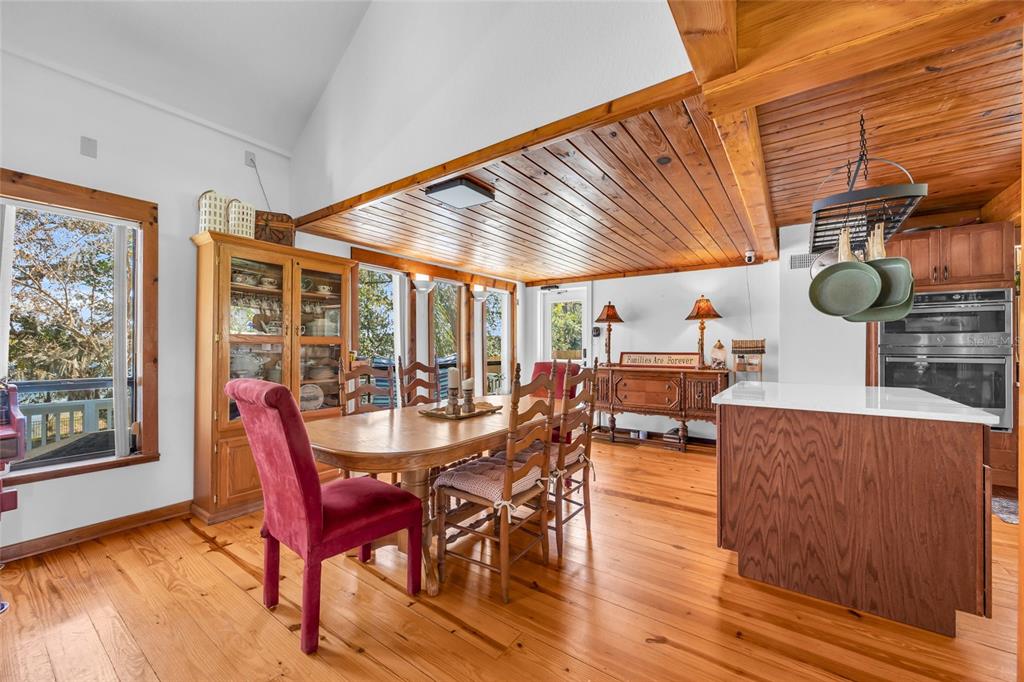 1217 Edgewood Ranch Road Orlando, FL 32835 - Photo 17 of 91 a dining room with furniture and a floor to ceiling window