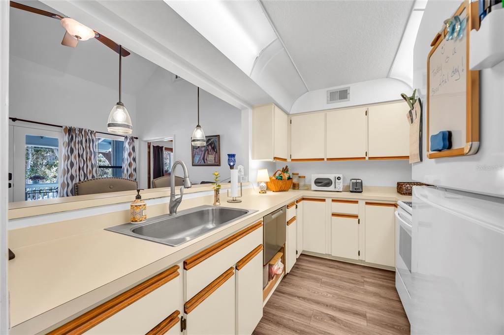 1217 Edgewood Ranch Road Orlando, FL 32835 - Photo 29 of 91 a kitchen with stainless steel appliances granite countertop a sink and cabinets