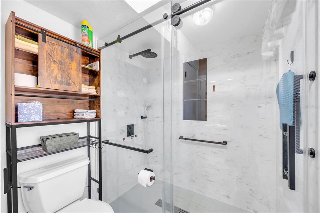 1217 Edgewood Ranch Road Orlando, FL 32835 - Photo 33 of 91 a bathroom with a shower and a toilet
