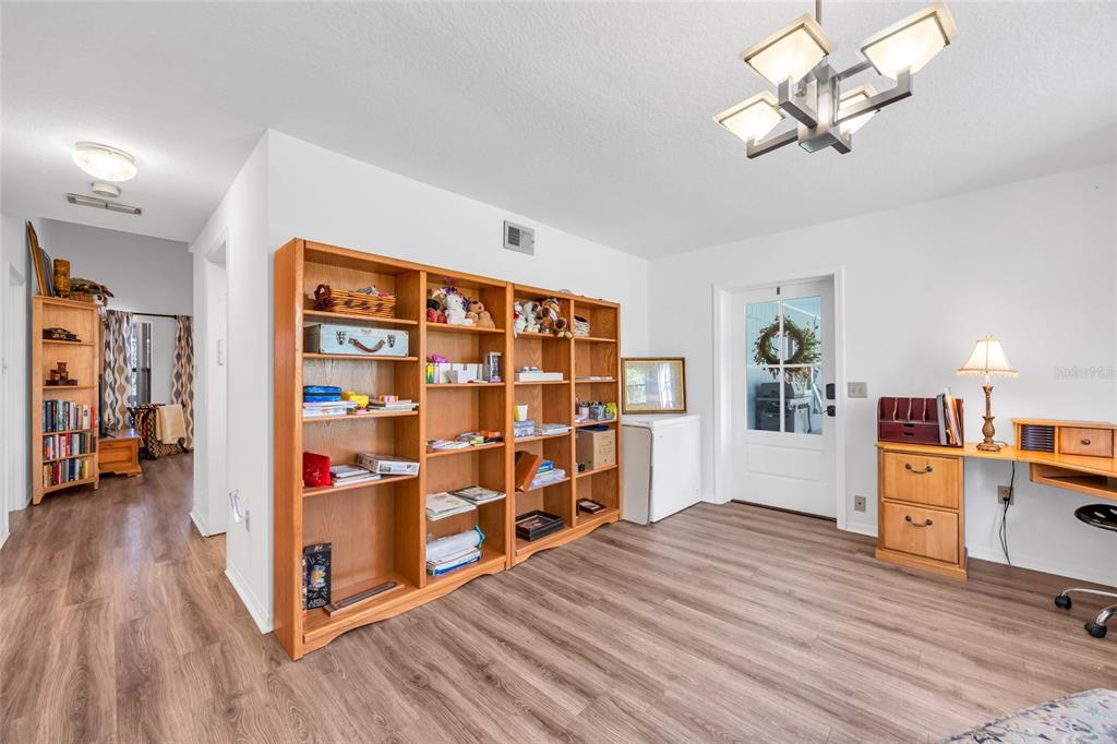 1217 Edgewood Ranch Road Orlando, FL 32835 - Photo 34 of 91 a view of a bedroom with cabinets and wooden floor