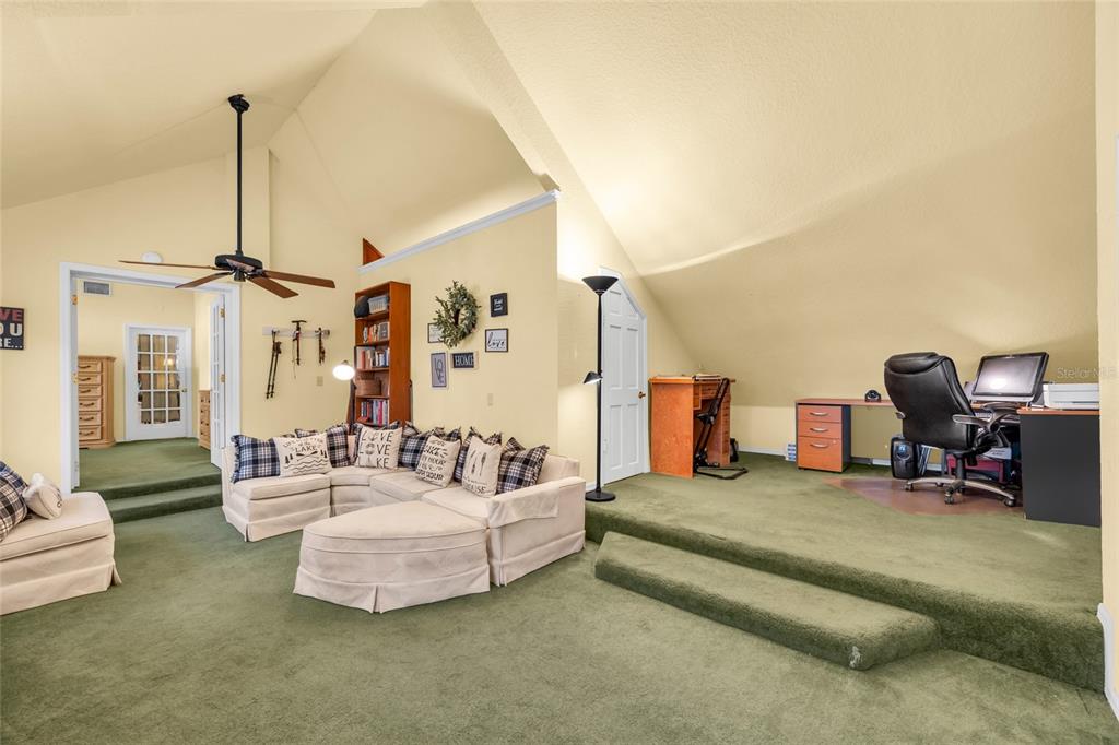 1217 Edgewood Ranch Road Orlando, FL 32835 - Photo 39 of 91 a living room with furniture a rug and gym equipment