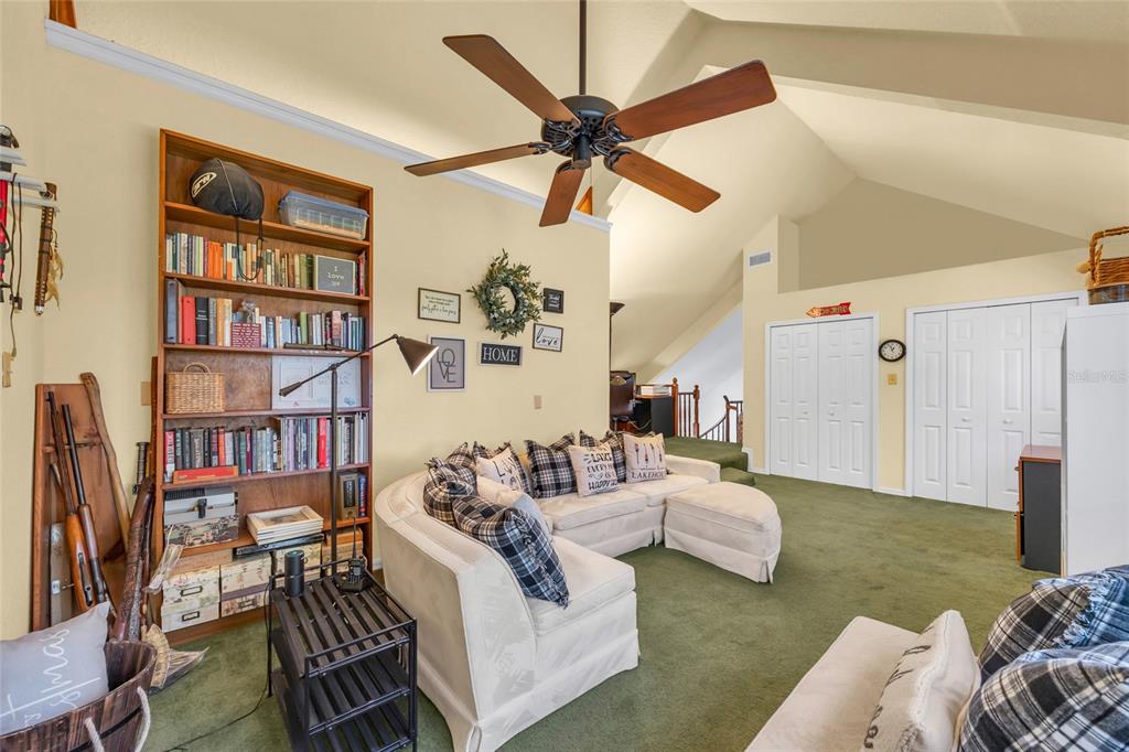 1217 Edgewood Ranch Road Orlando, FL 32835 - Photo 40 of 91 a living room with furniture and a book shelf