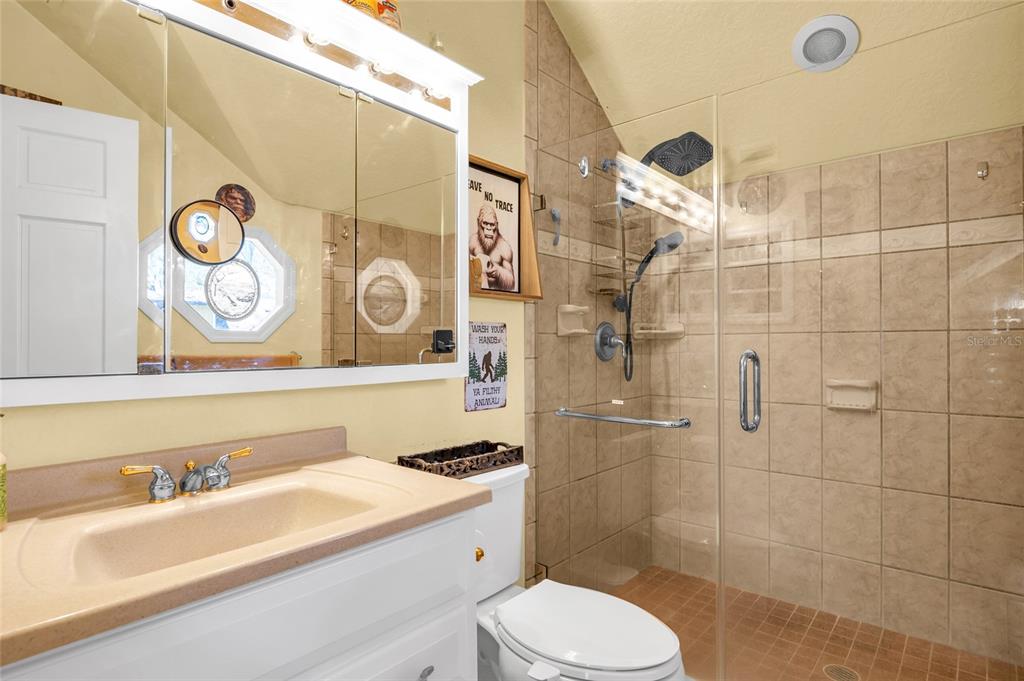 1217 Edgewood Ranch Road Orlando, FL 32835 - Photo 47 of 91 a bathroom with a sink a toilet and shower