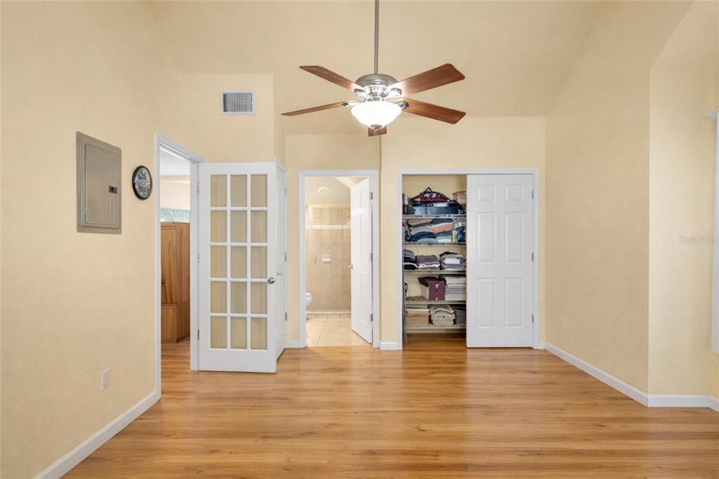 1217 Edgewood Ranch Road Orlando, FL 32835 - Photo 49 of 91 a view of a livingroom with wooden floor closet and a ceiling fan