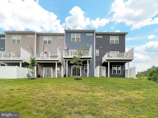 a front view of a house with a garden and plants