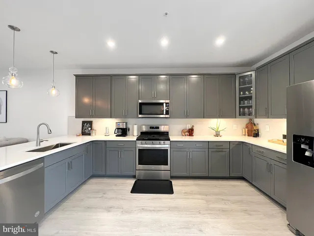 a kitchen with sink cabinets and stainless steel appliances
