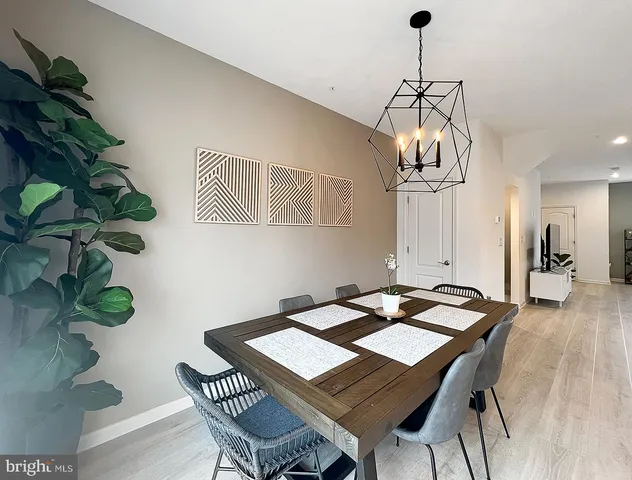 a view of a dining room with furniture wooden floor and chandelier