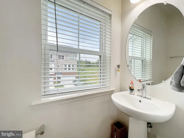 a bathroom with a sink a mirror and a window