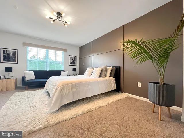 a bedroom with a bed lamps and a chandelier