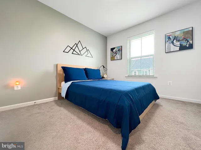 a bedroom with a large bed and a window